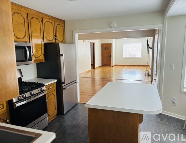 A kitchen with wooden cabinets and a black stove top oven.