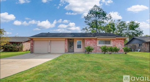 A house with a red brick exterior and a black roof is for sale.