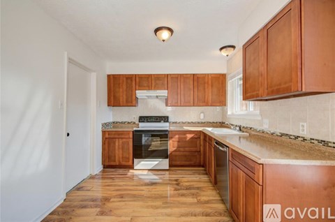 A kitchen with wooden cabinets and a stove top oven.