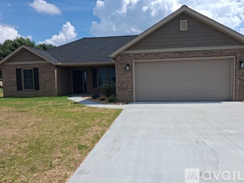 A house with a garage and a driveway in front.