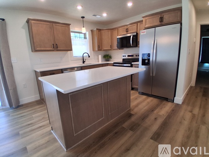A kitchen with wooden cabinets and a white countertop.