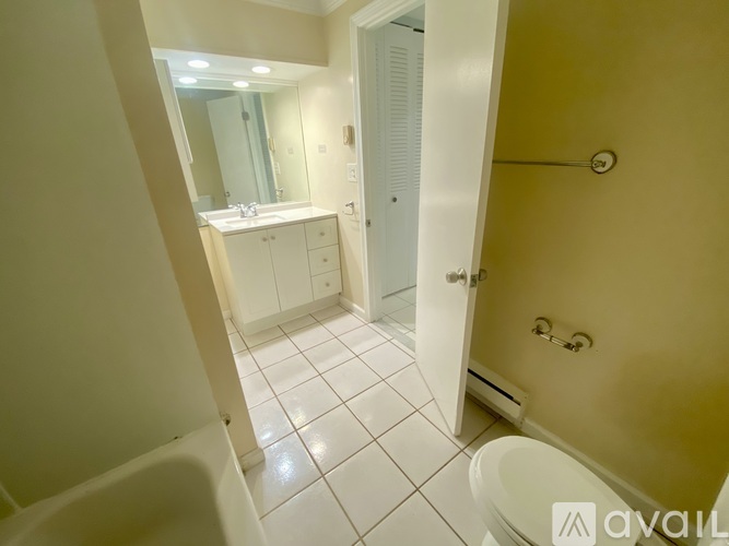 A bathroom with a white tub and sink.