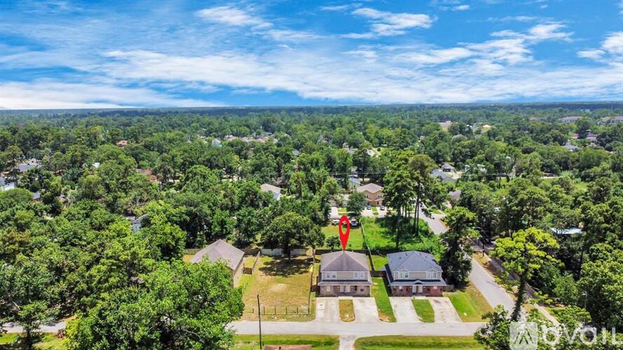A bird's eye view of a residential area with houses and trees.