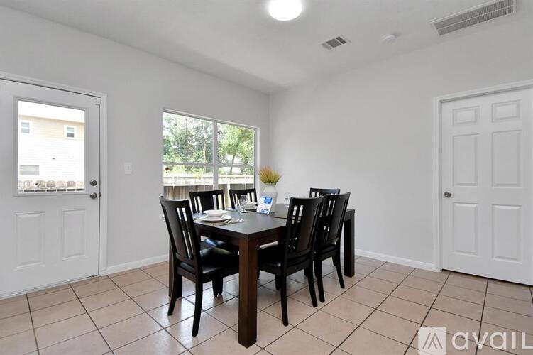 A dining room with a table set for four.