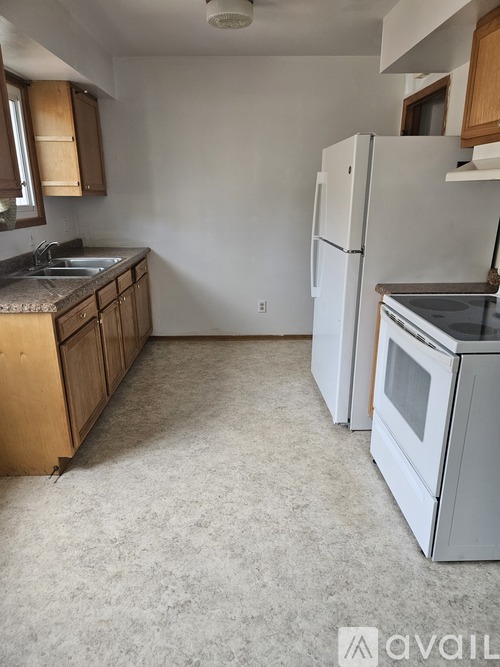 A kitchen with a white fridge and a white oven.
