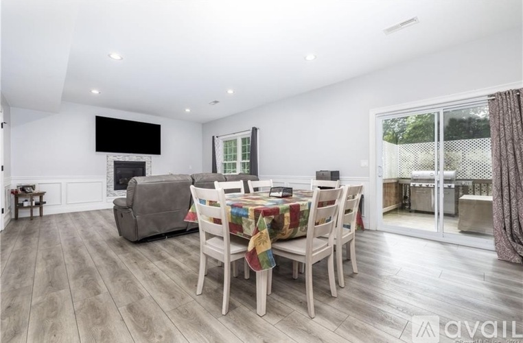 A modern dining room with a wooden table and chairs.