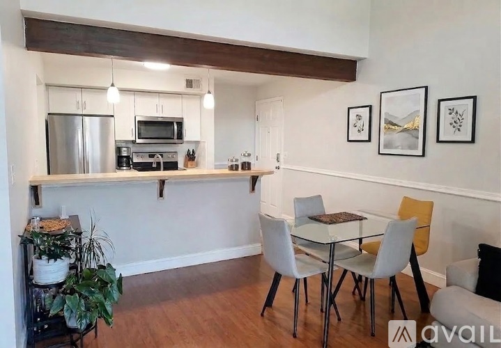 A kitchen area with a table and chairs.