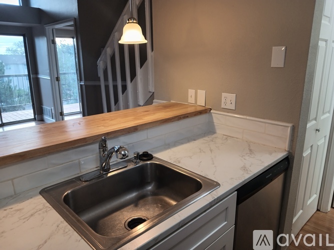 A kitchen with a sink and a window.