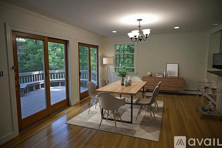 A dining room with a wooden table and chairs.