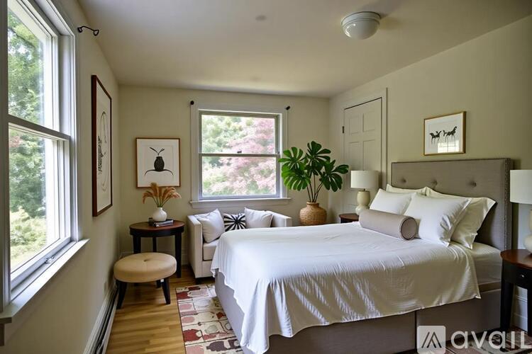 A bedroom with a large bed and a window.