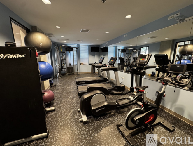 A gym with treadmills, exercise bikes, and a weight machine.