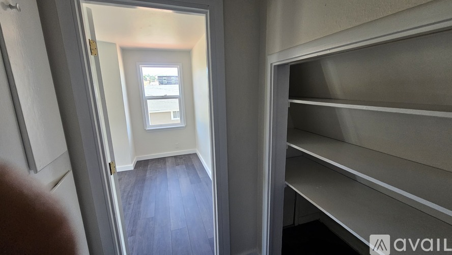 A view from the hallway into a room with a window.