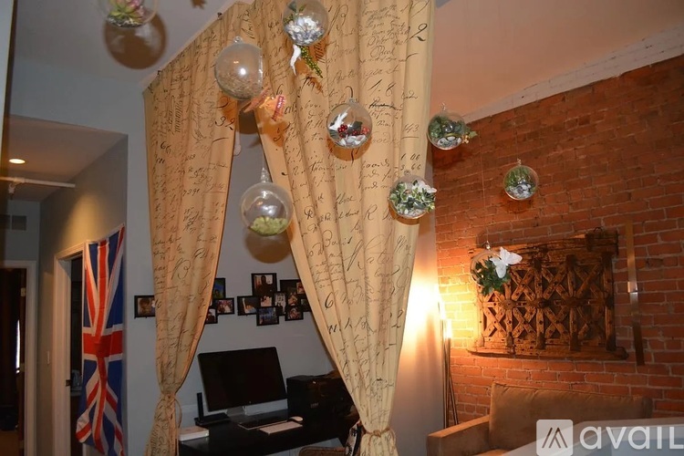 A room with a piano, a flag and a wall with writings on it.