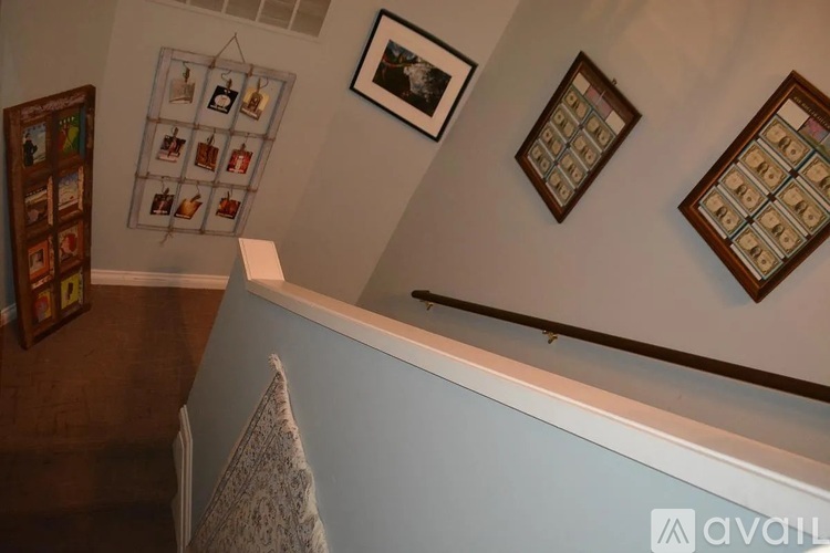 A staircase with a white railing and a light blue wall.