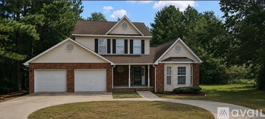 A two-story house with a garage is for sale.