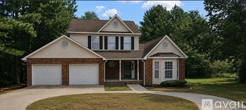 A two-story house with a garage is for sale.
