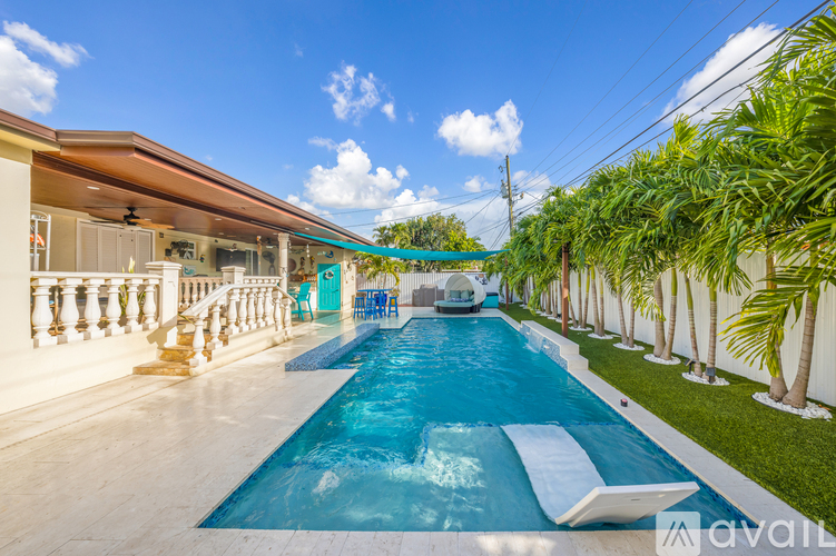 A long rectangular pool with a slide in the middle.