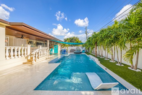 A long rectangular pool with a slide in the middle.