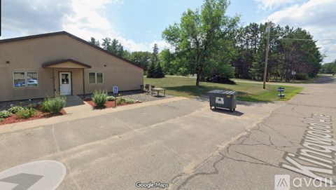 A building with a parking lot in front of it.
