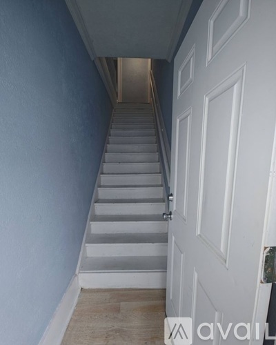 A staircase with a white door on the side.