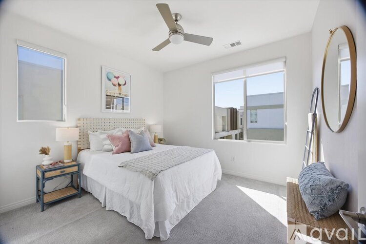 A bedroom with a large bed and a ceiling fan.