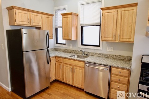 A kitchen with a stainless steel refrigerator and oven.