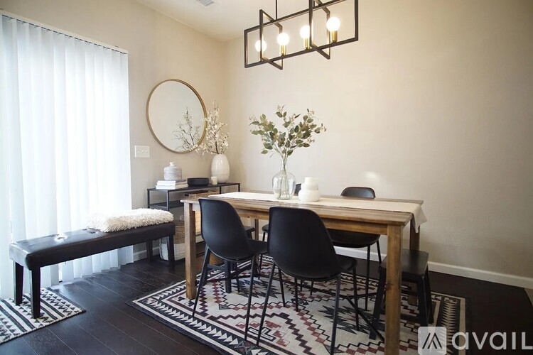 A dining room with a wooden table and chairs.