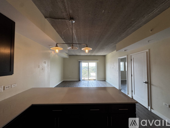 A spacious room with a large table and a television on the wall.