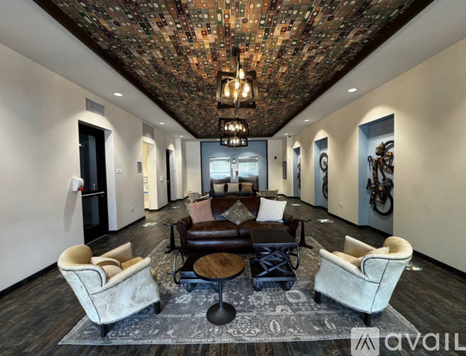 A living room with a brick ceiling and a large couch.