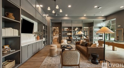 A modern living room with a variety of furniture and decor.