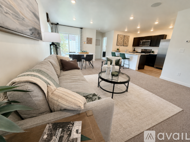 A living room with a grey couch and a coffee table.