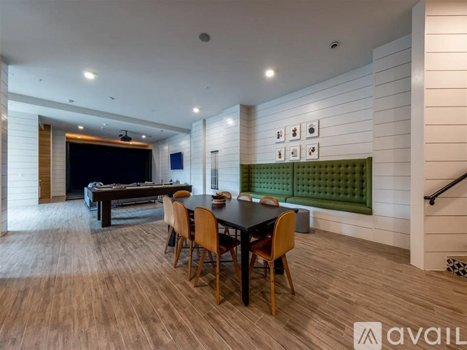 A modern dining room with a dark wood table and chairs.
