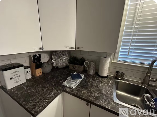 A kitchen counter with a box of Slope brand tea on it.