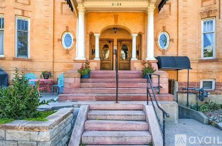 A house with a front porch and steps leading to the entrance.
