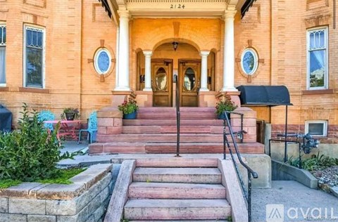 A house with a front porch and steps leading to the entrance.