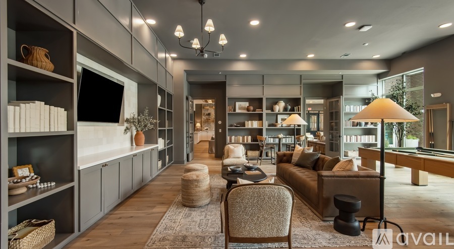 A modern living room with a variety of furniture and decor.
