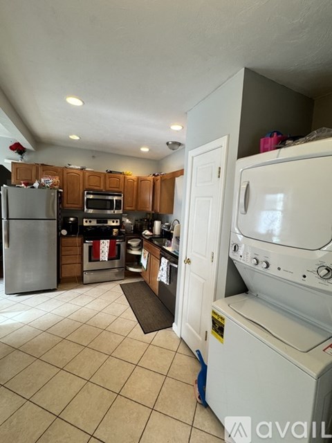 A kitchen with a refrigerator, oven, and microwave.