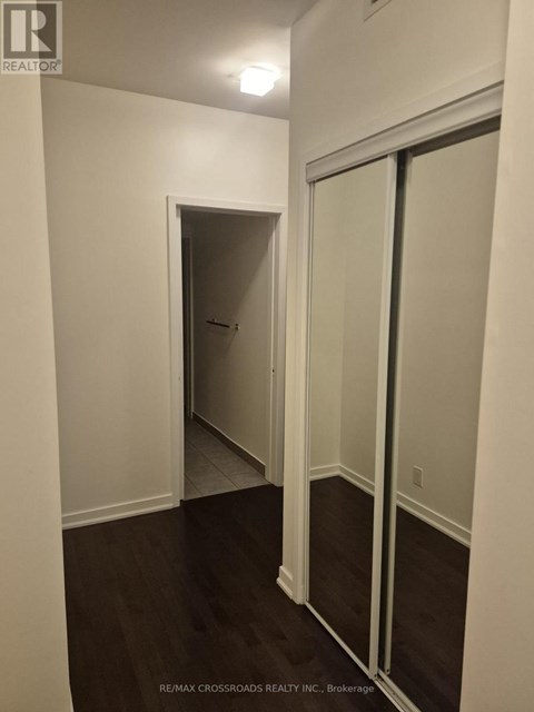 A hallway with a door on the left and a sliding door on the right.