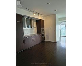 A white door is in a room with a wooden floor.