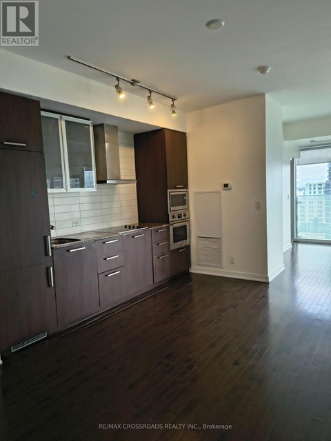 A white door is in a room with a wooden floor.