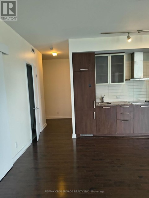 A dining room with a table set for four and a white wall.