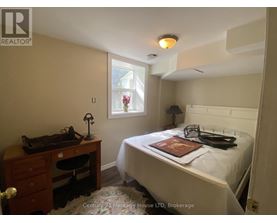 A bedroom with a bed, desk, and chair.