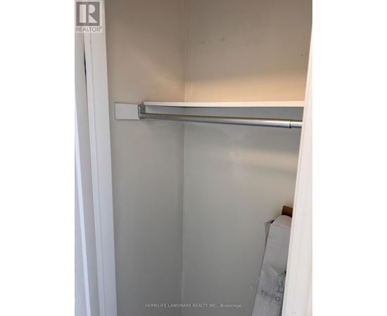 A white closet with a metal rod hanging from the top.