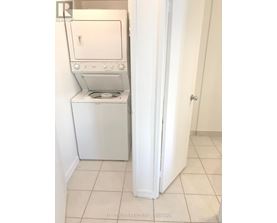 A white dryer and washer in a small laundry room.