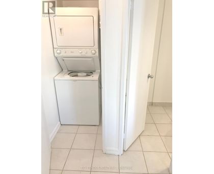 A white dryer and washer in a small laundry room.