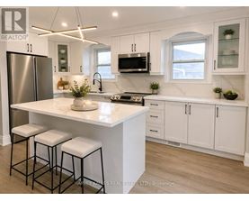 A modern kitchen with white cabinets and a central island.