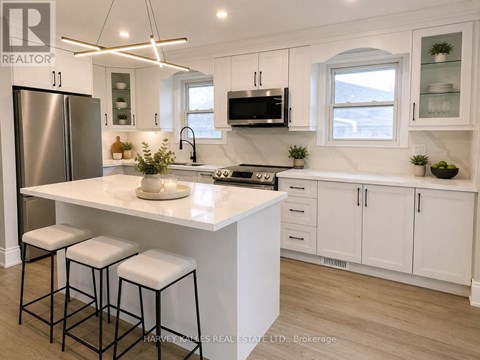 A modern kitchen with white cabinets and a central island.