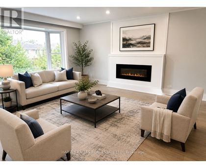 A living room with a fireplace and a painting on the wall.