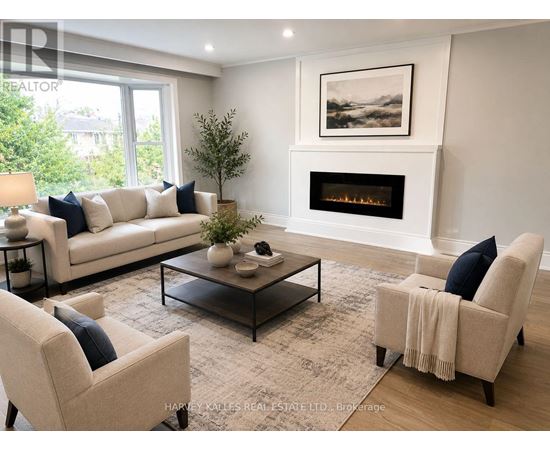A living room with a fireplace and a painting on the wall.