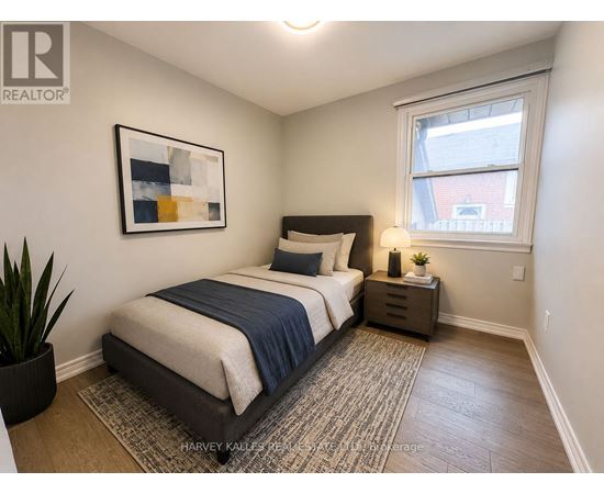 A bedroom with a bed, nightstand, and a painting on the wall.